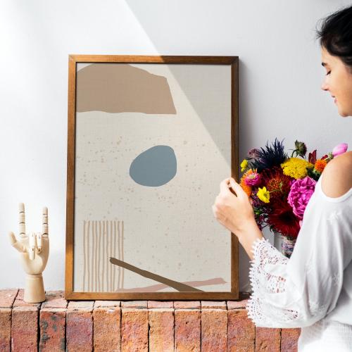 Girl decorating a wall with a frame mockup - 1210143