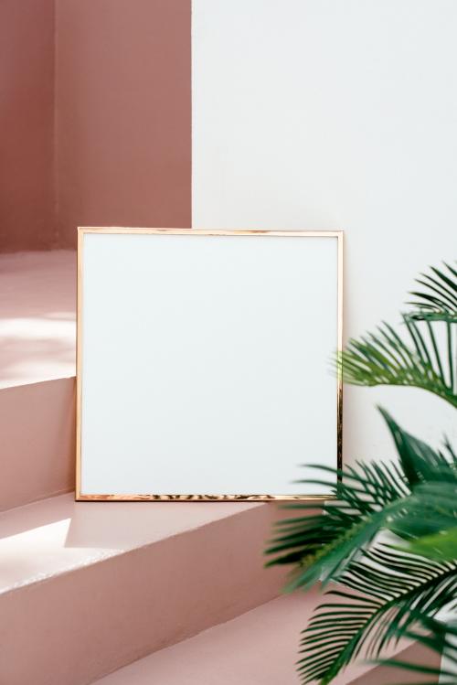 Golden shiny frame mockup on a pink stairway - 1210153