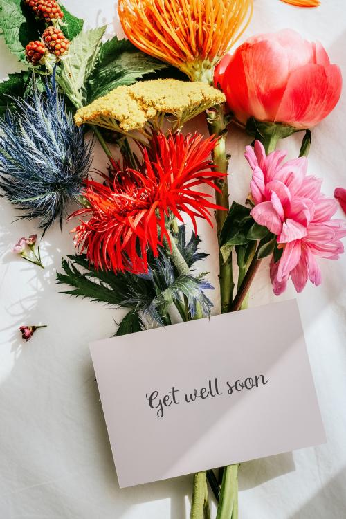 Bouquet of colorful flowers on a white bed sheet with a card mockup - 1210255