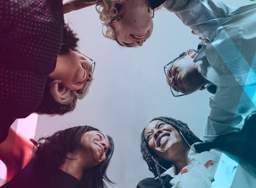 Happy diverse businesswomen huddling in the office - 1211523