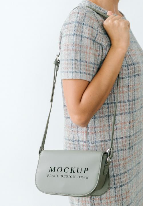 Woman in a gray plaid dress with a gray purse mockup - 1215124