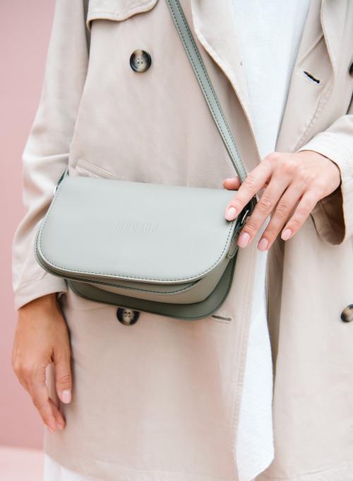 Woman in a beige coat with her shoulder bag mockup - 1215128