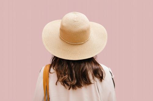 Rearview of a brown hair woman in a woven hat - 1215166