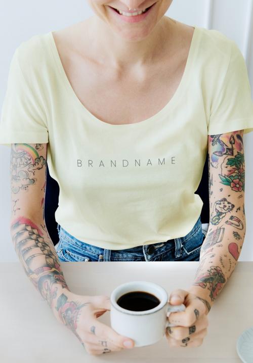 Smiling tattooed woman having a cup coffee mockup - 1215268