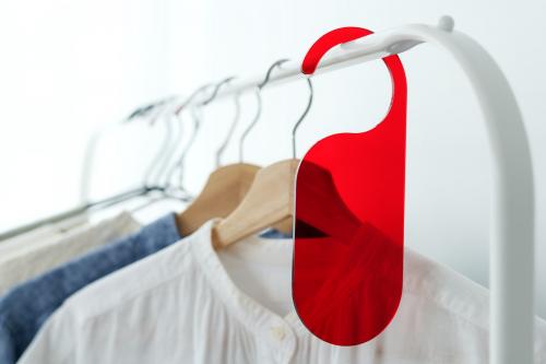 Shirt on a clothing rack with a red tag mockup in a studio - 1215335