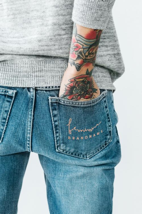 Tattooed woman with her hand in her jeans pocket mockup - 1215337