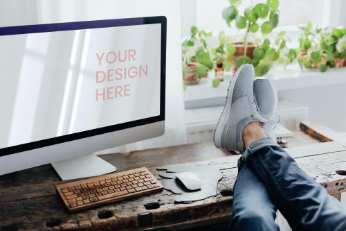 Lazy man putting his feet up on the workstation - 1198154