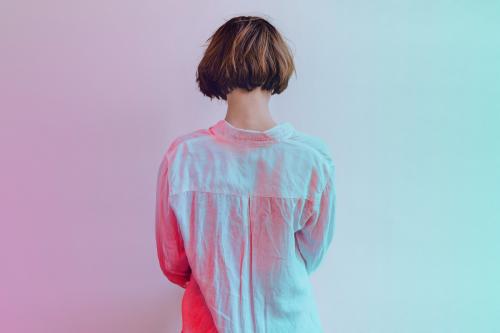 Rear view of a short dyed hair in a white shirt - 1200470