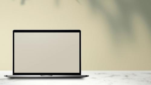 Laptop with screen mockup on a white marble table - 935110