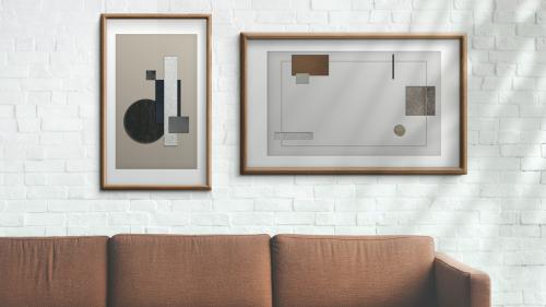 Picture frames hanging on a white brick wall illustration - 935240