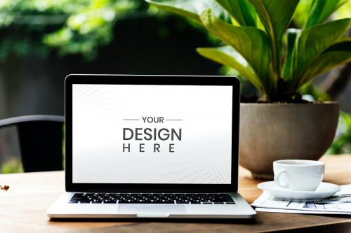 Laptop on a wooden table in a garden - 844059