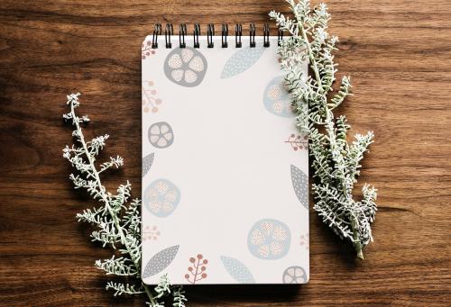 Doodle patterned notebook on a wooden table illustration - 844853