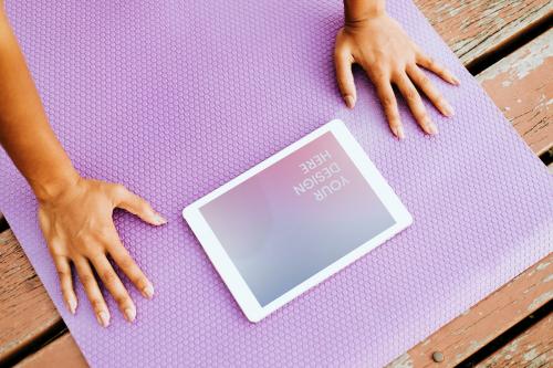 Woman doing yoga using a tablet screen mockup - 894823