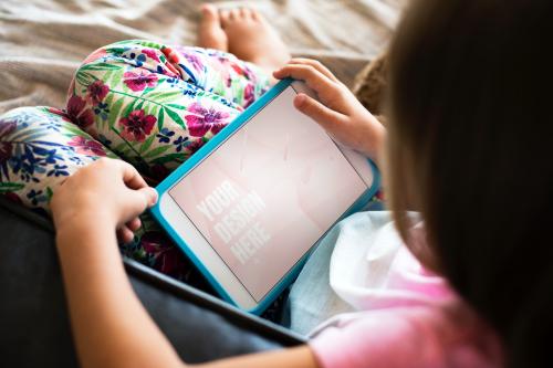 Young girl using a digital tablet with a screen mockup - 894850