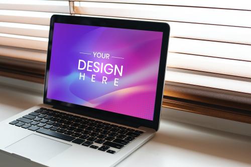 Digital laptop screen mockup on a table by the window - 894865