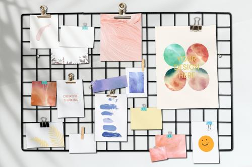 Postcard mockup on a rack against a white wall - 894893