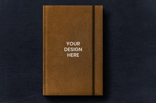 Brown book cover mockup on a black table - 894906