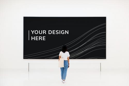 Rear view of a woman looking at a black board mockup - 598432