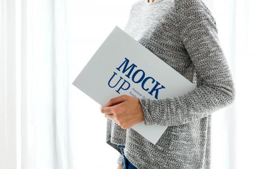 Woman in a gray top holding a board mockup - 598433