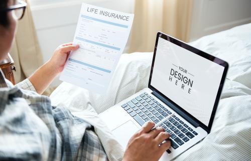 Sick man considering life insurance with a notebook on his lap - 598434