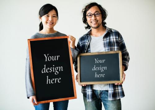 Asian couple is holding blackboard mockups - 598452