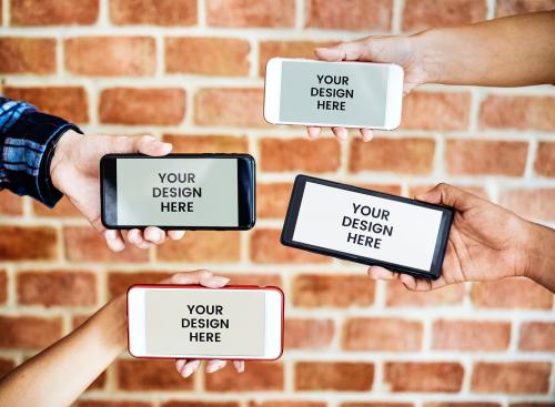 People showing phones mockup in front of a brick wall - 598455