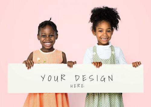 Cheerful little black girls holding a banner mockup - 666151