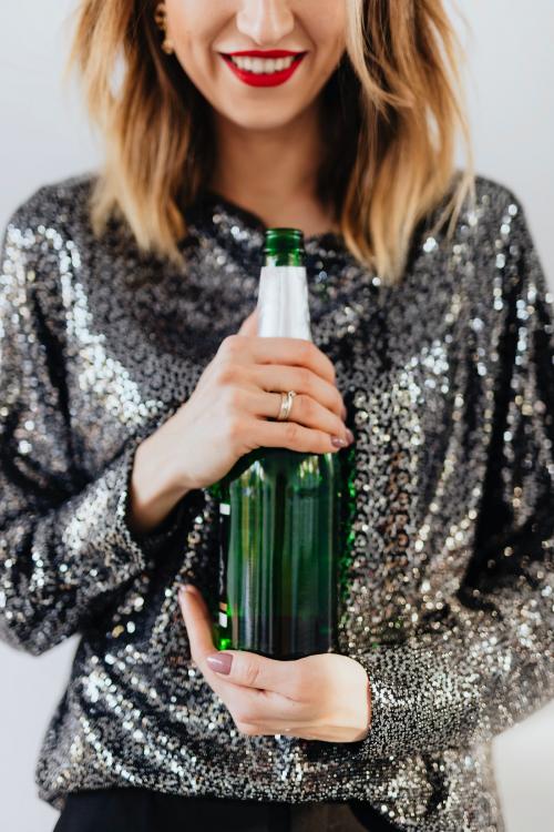 Woman holding a champagne bottle - 2035391