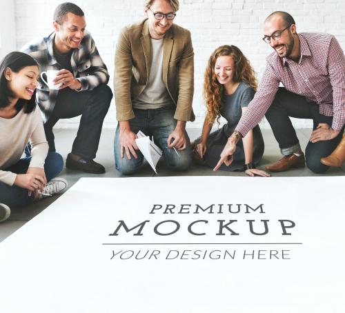 Diverse team discussing a poster mockup - 666173