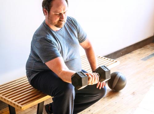 Man lifting a heavy dumbbell - 2046927