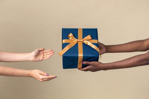 Woman giving a present to her friend - 2056068