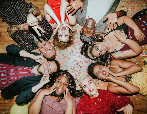 Group of friends lying on the floor at a party - 2097347