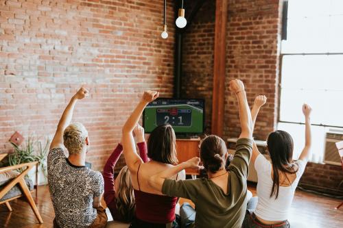 Friends watching a game show on the tv - 2204690