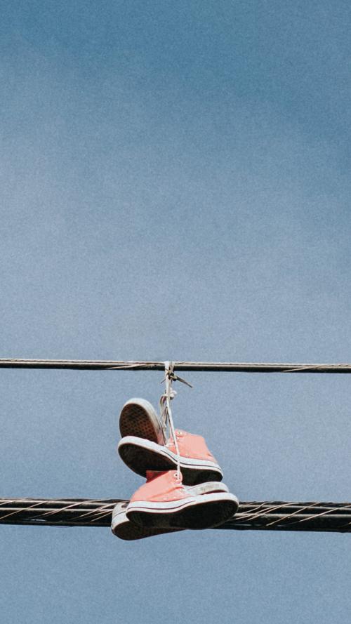 Pink sneakers hanging on an electricity line in downtown LA mobile wallpaper - 2263084