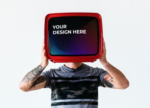 Man with a tattoo holding a television mockup - 580827