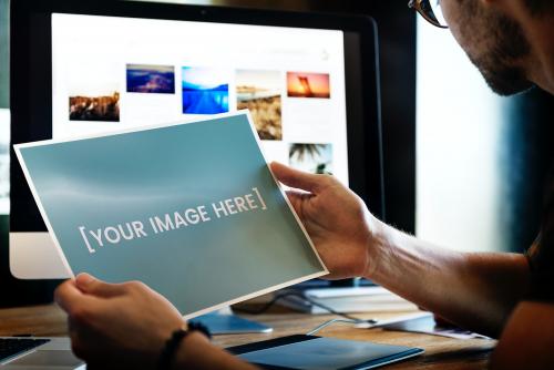 Photographer holding a photograph mockup - 580872