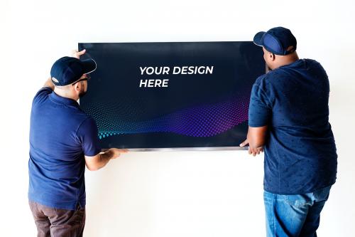 Technician installing a TV mockup on a white wall - 580874