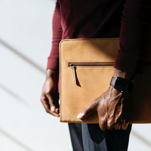 Man with a wristwatch holding a brown briefcase social template - 2025391