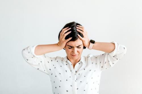 Stressed woman holding her forehead - 2030325