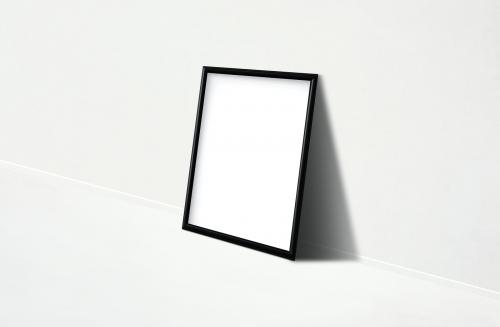 Black frame mockup against a white wall - 586039