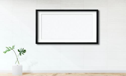Black frame mockup against a white wall - 586135