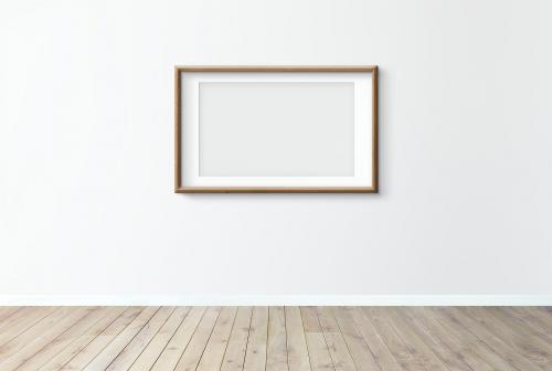 Blank frame mockup on a white wall - 586139