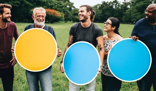 Happy diverse people holding round empty boards in the park - 537797