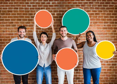 Diverse people holding colorful round boards - 537864