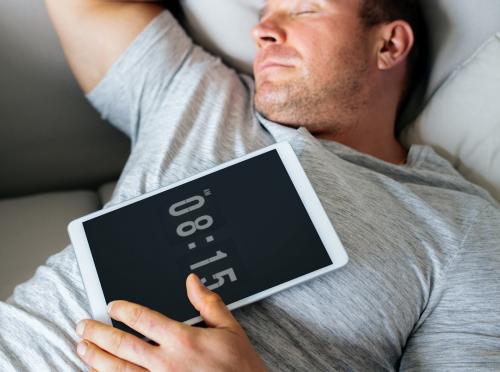 Man asleep on the sofa with his tablet on his chest - 538886