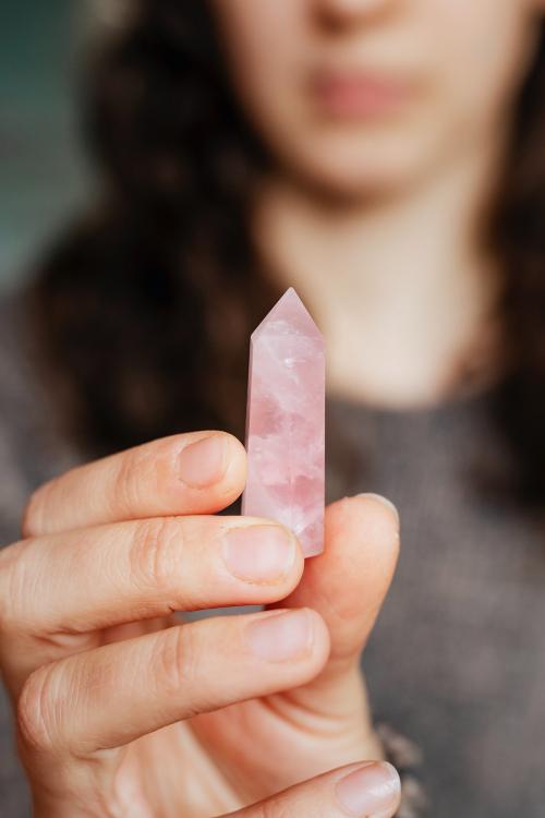 Woman holding a rose quartz crystal - 2285572