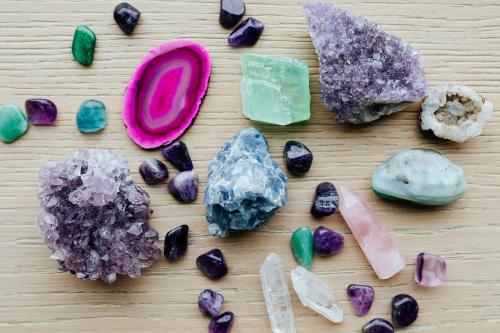 Colorful healing crystals on a wooden table - 2285588