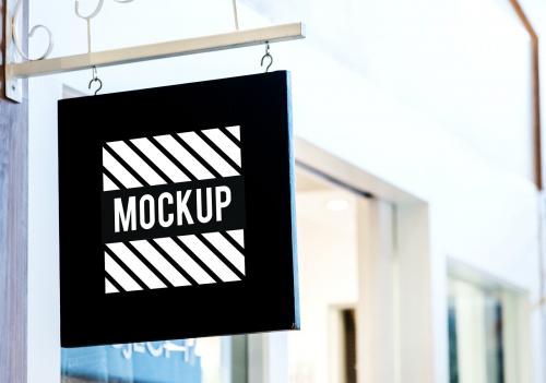 Black sign mockup outside a shop - 545191