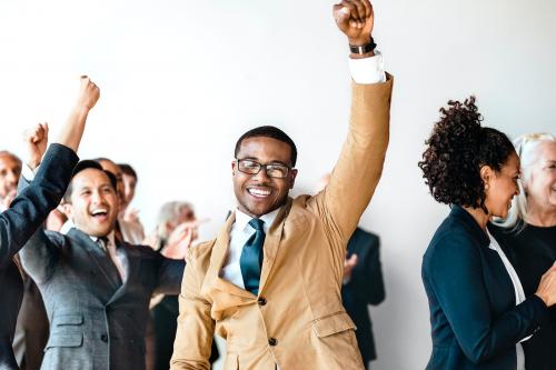 Cheerful businesspeople raising hands in the air - 2020120