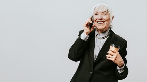 Professional woman with a coffee in a black suit - 2020130